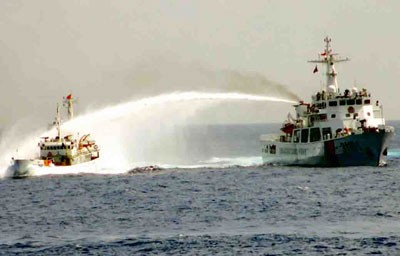 A Chinese ship (R) fires water cannon at a Vienamese coast guard vessel A Chinese ship (R) fires water cannon at a Vienamese coast guard vessel